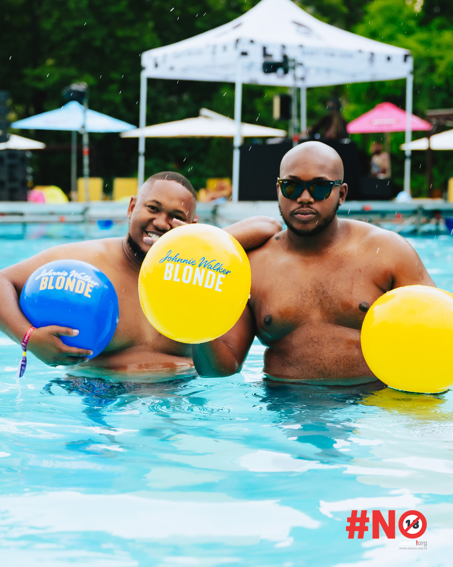 Two guests with beach balls in the pool