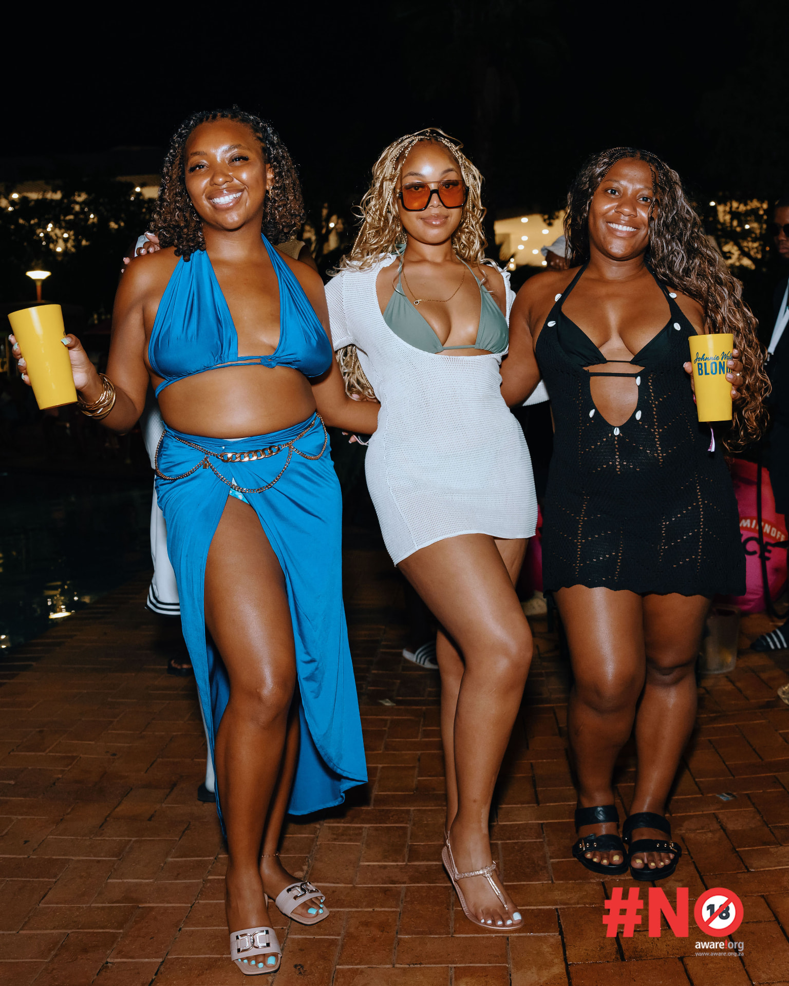 Three guests in elegant outfits enjoying the night party