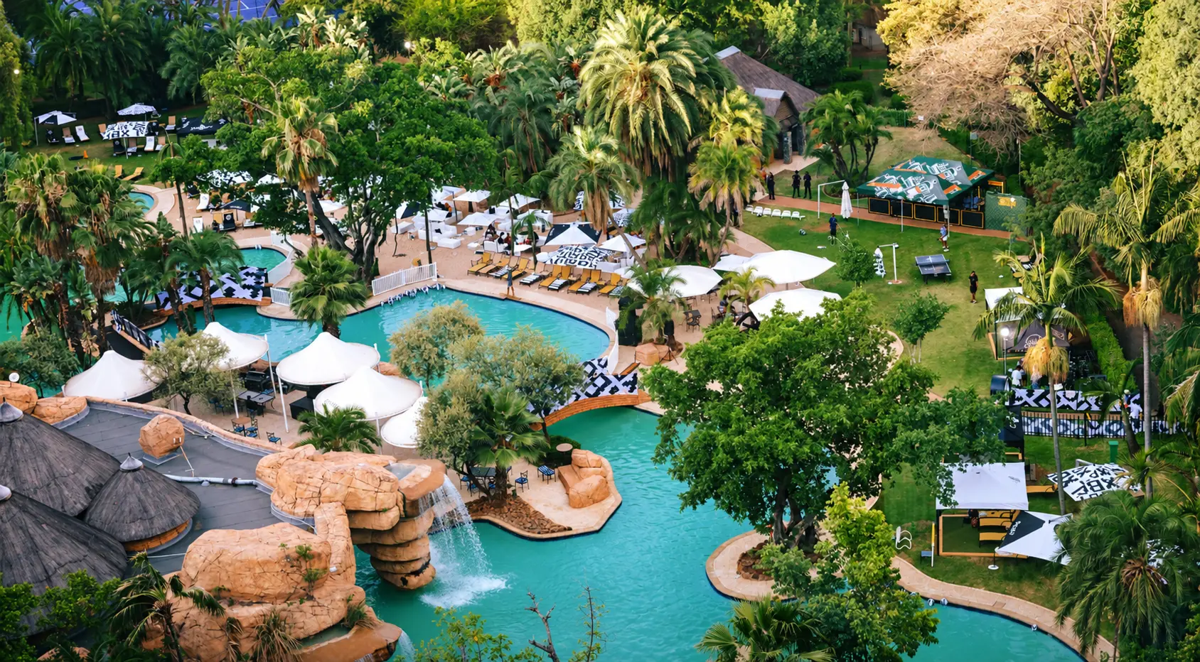 Aerial view of the Sun City Resort pools and palm trees